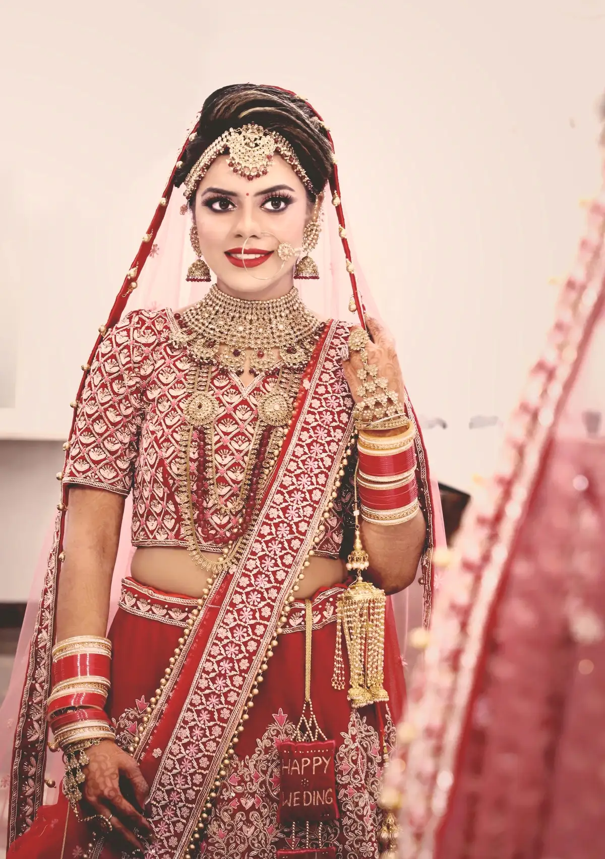 a bride in red saree and bridal makeup